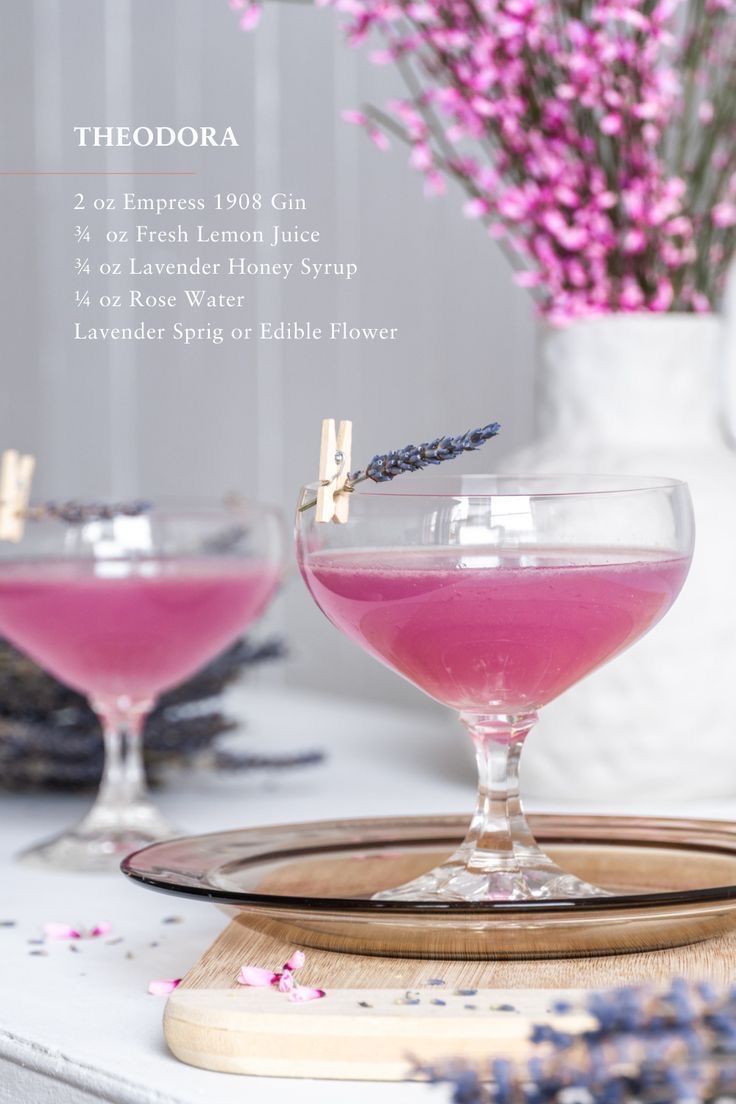 two glasses filled with pink liquid and lavender sprinkles