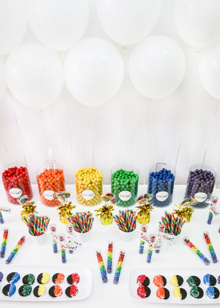 a table topped with lots of candy and balloons