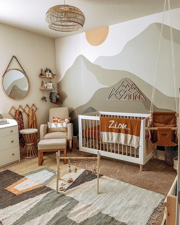 a baby's room with mountains painted on the wall