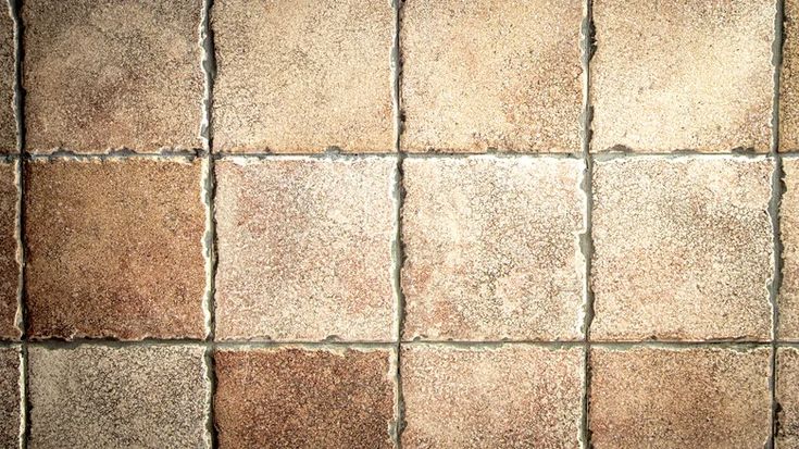 a brown and white tiled floor with small squares