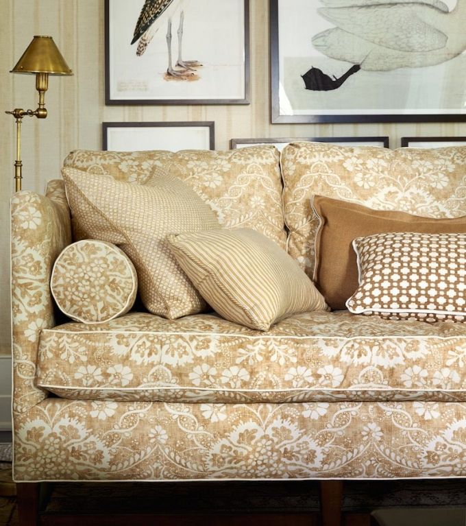 a living room filled with furniture and pictures on the wall