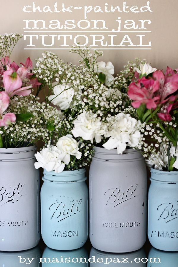 four painted mason jars with flowers in them