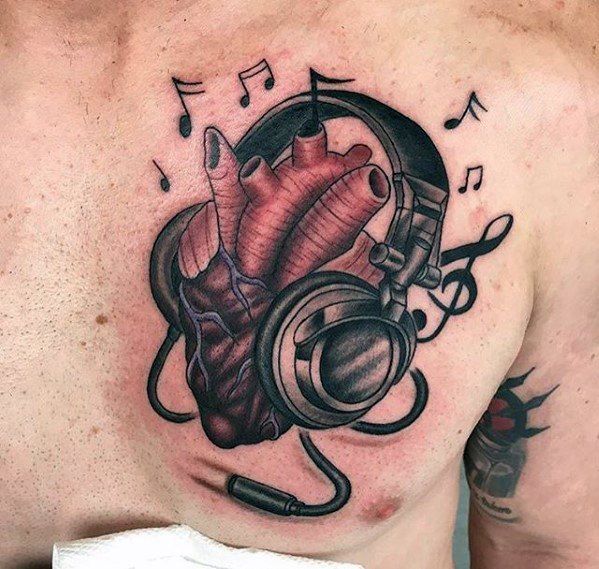 a heart with headphones and music notes on it's chest is seen in this tattoo