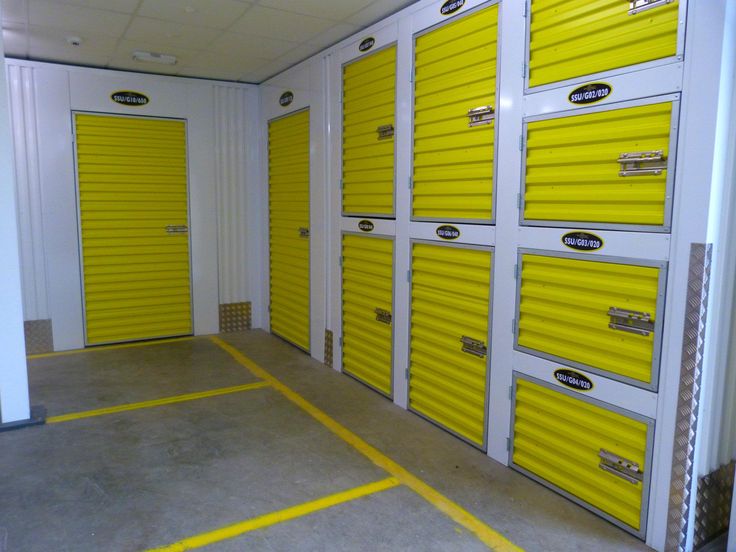 several storage units with yellow doors and white walls