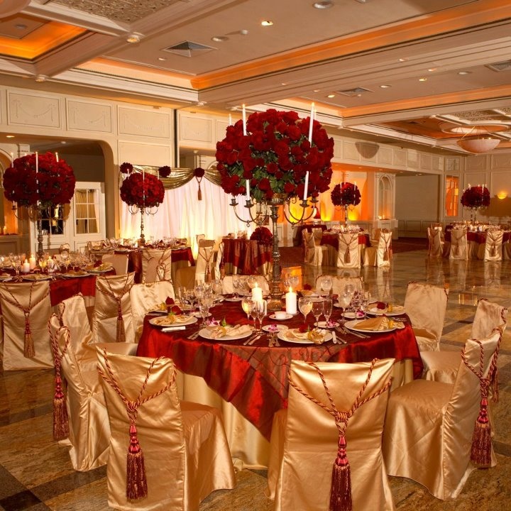 a banquet room set up with red and gold decorations