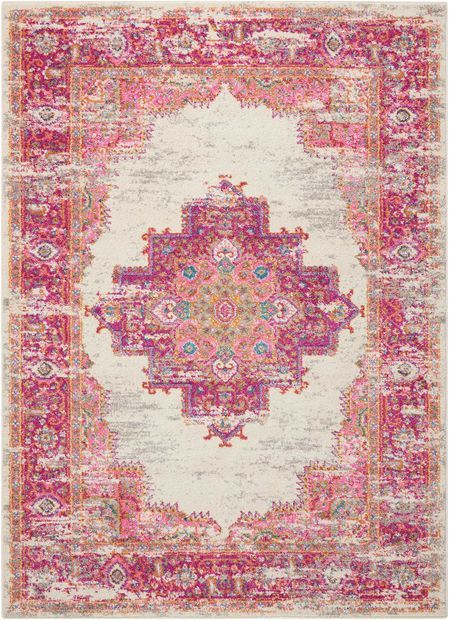 a pink and white rug with an ornate design on the center, surrounded by colorful flowers