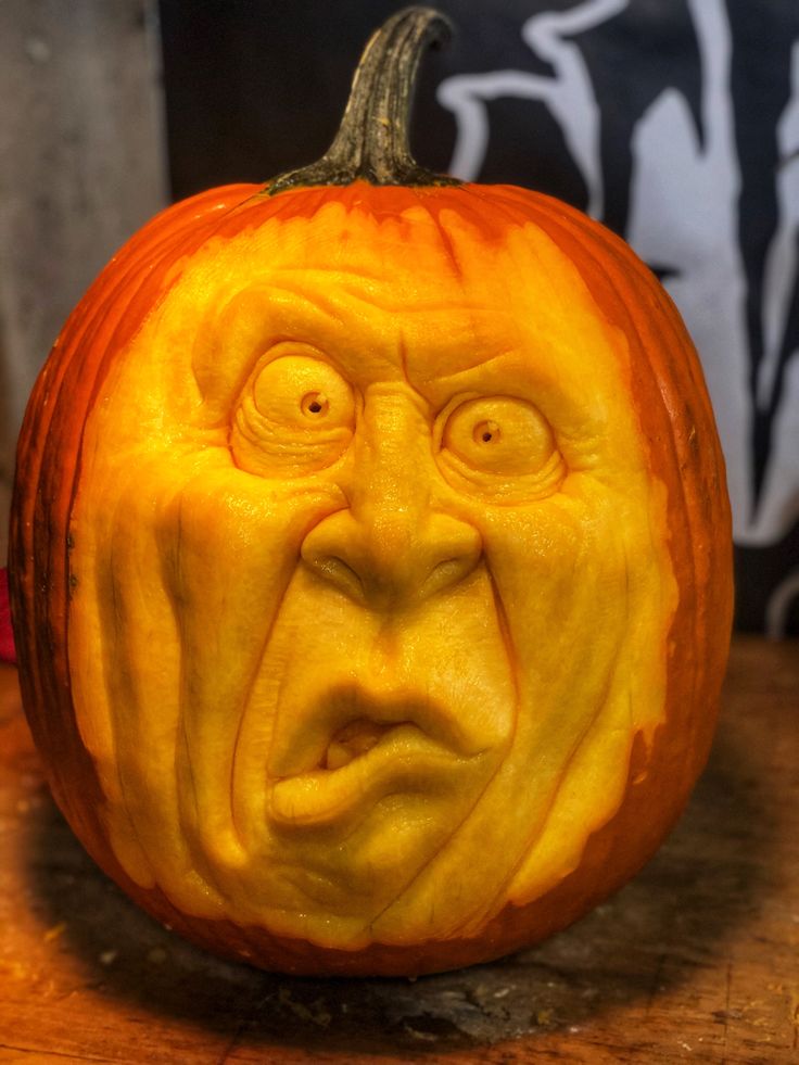 a carved pumpkin with an angry face on it