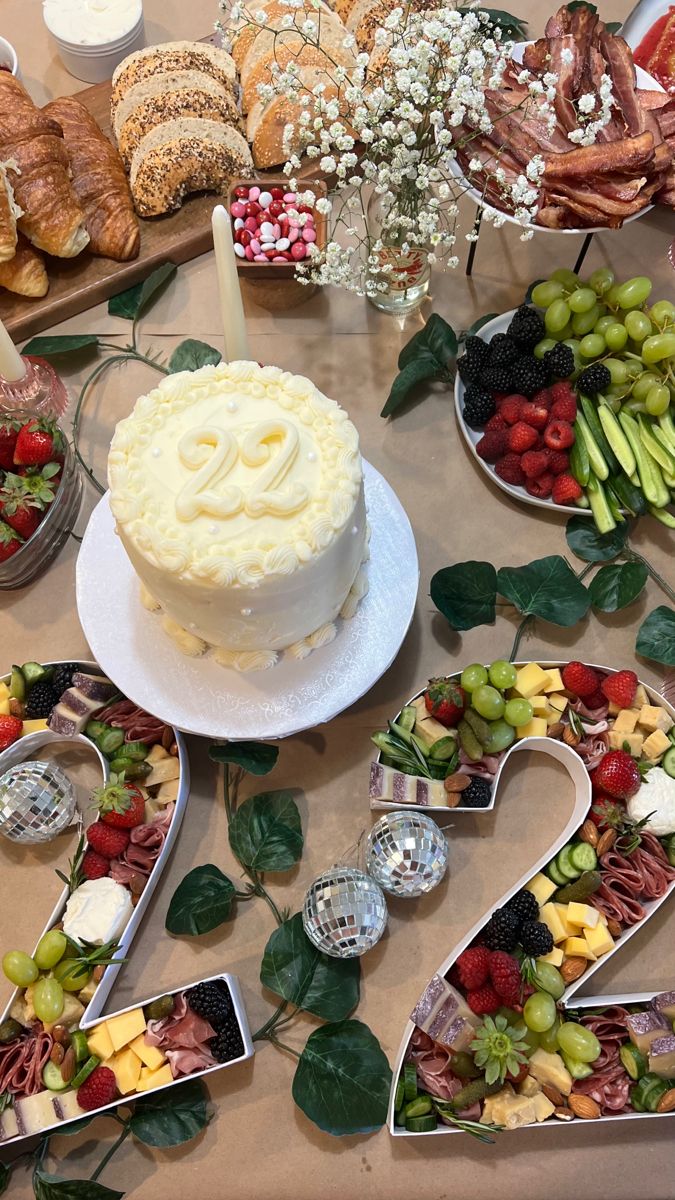 a table topped with lots of different types of cakes and fruit on top of plates