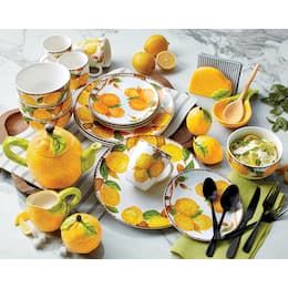 a table topped with plates and bowls filled with oranges next to utensils