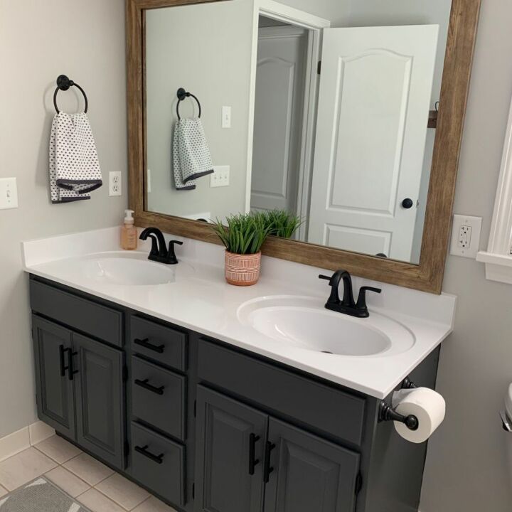 a bathroom with two sinks and a large mirror over the top of the sink area