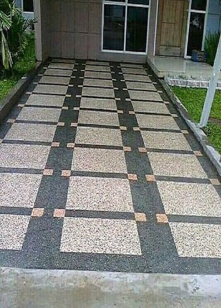 a driveway with a checkerboard pattern on it