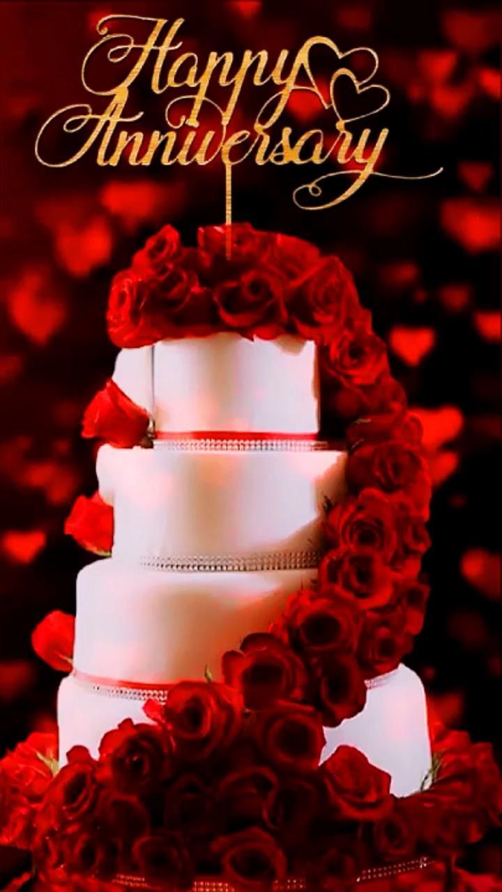 a red and white wedding cake with roses on it's side, says happy anniversary