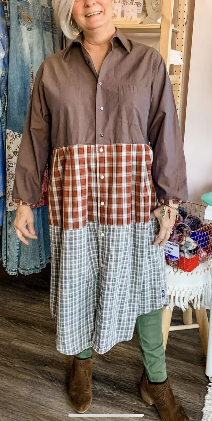 a woman standing in front of some clothes