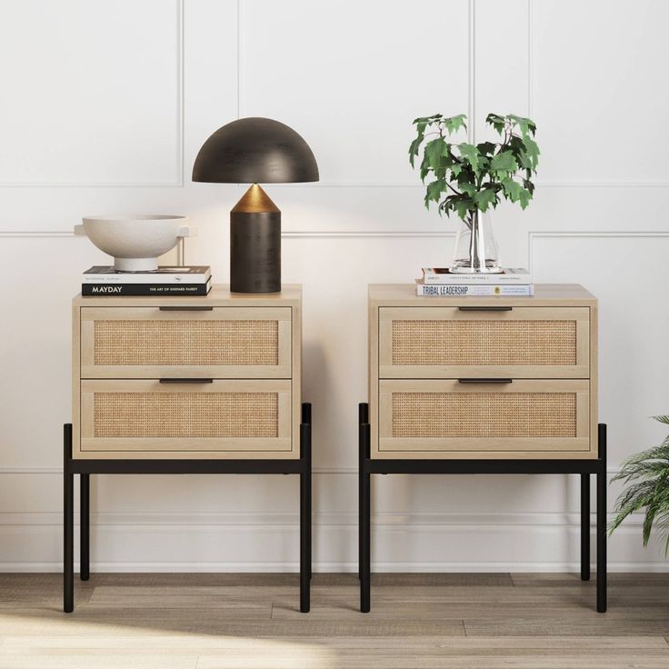 two nightstands with plants and books on them