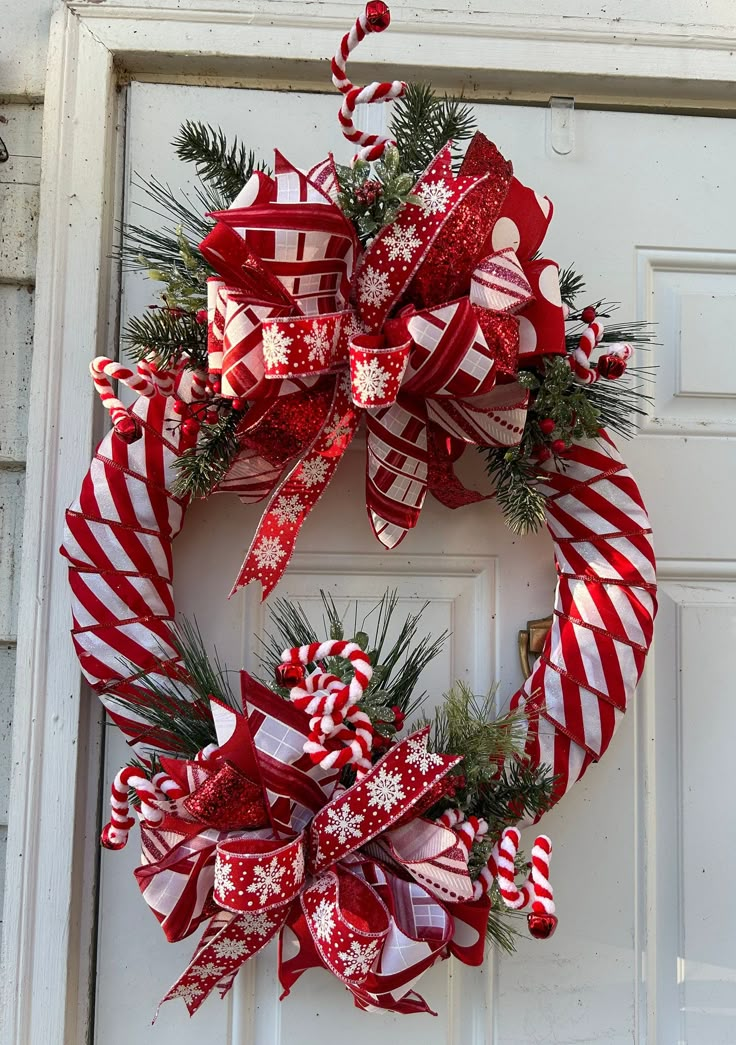 a red and white wreath with candy canes