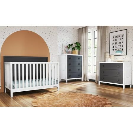 a baby's room with a white crib, dresser and bed in it