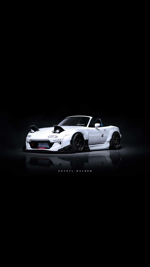 a white sports car is shown in the dark