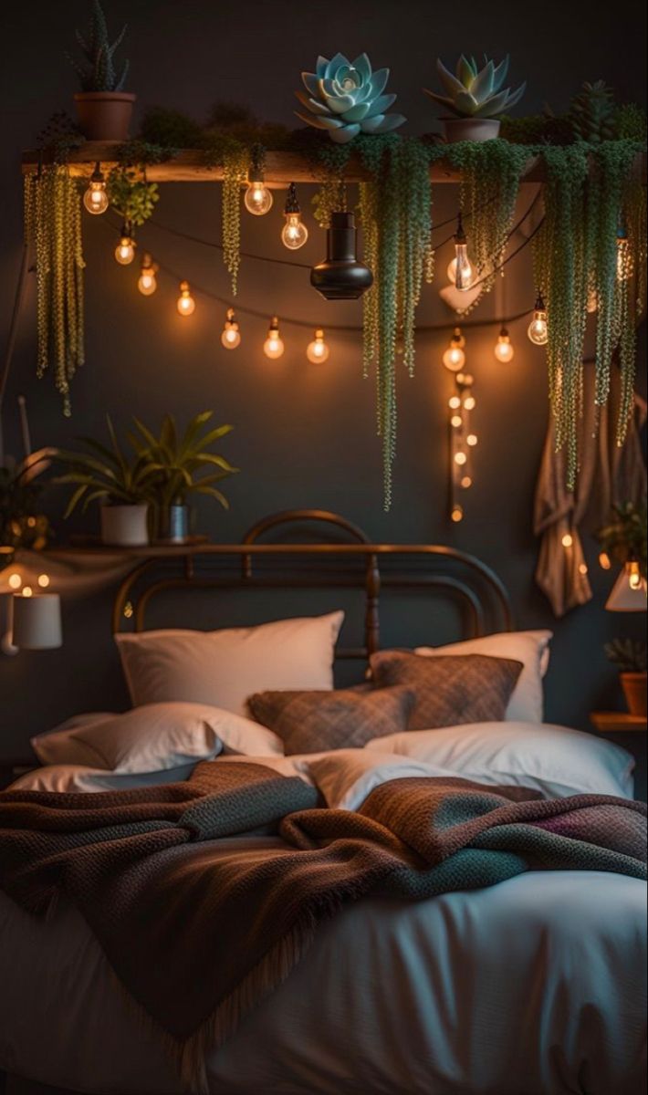 a bed with lots of lights hanging from it's headboard and pillows on top of it