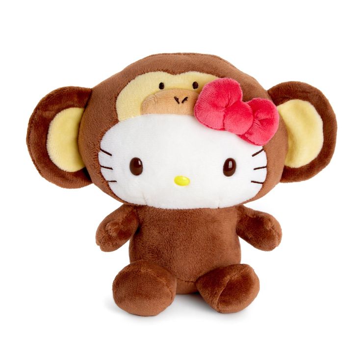 a stuffed animal with a bow on it's head sitting next to a white background