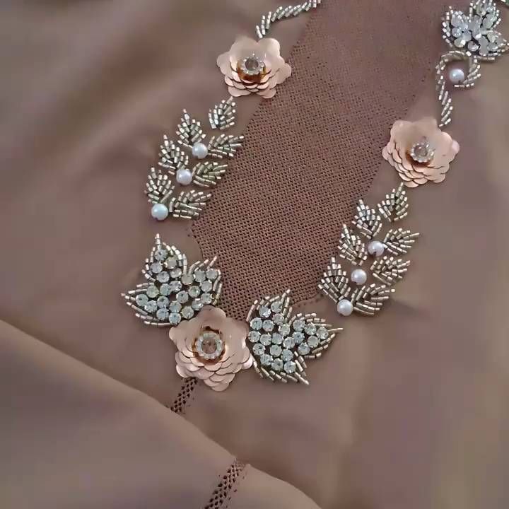 the necklace is adorned with flowers and pearls