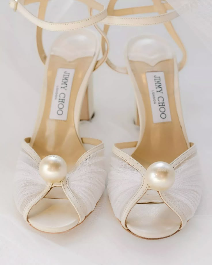 the bride's shoes are adorned with pearls