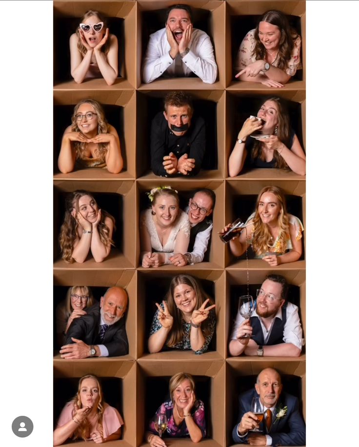 a group of people are posing for a photo in an open box with their hands up