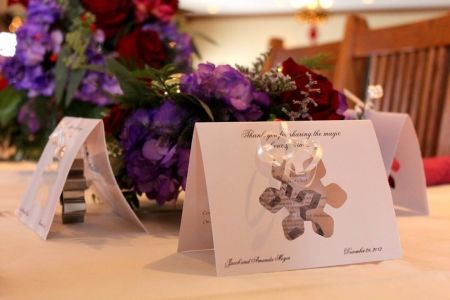 there are two cards on the table with flowers in the vases behind them, and one is for someone's special occasion