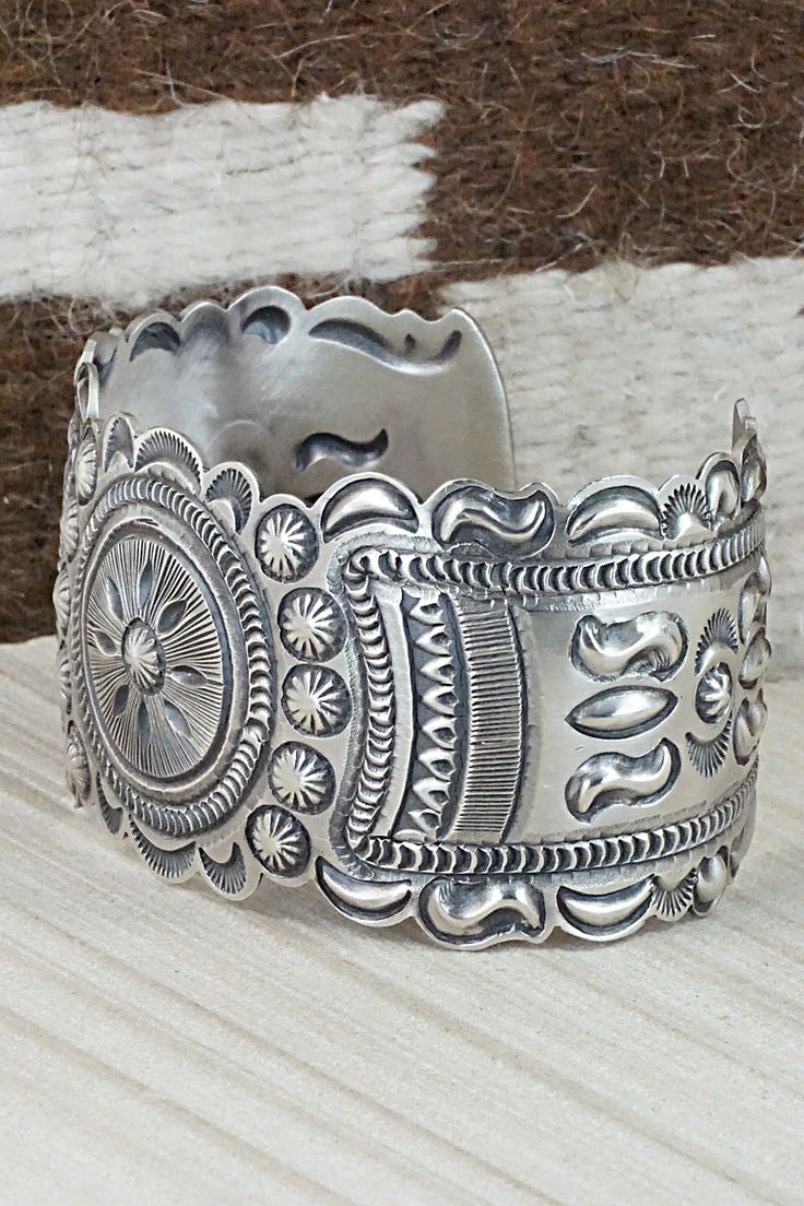 This sterling silver bracelet was made by Navajo silversmith Eugene Charley. The inside is signed and stamped sterling.Size: 5 3/4" (will fit up to a 7" wrist)Gap: 1 1/4"Width: 1 1/2"Free shipping on all orders! We ship with USPS and always include tracking. All orders ship within a day of payment.Returns are accepted up to 30 days after you receive your order. Just send us a message. Our shop offers cash back or store credit. The item must be returned in new condition. Stamped Sterling Silver Bohemian Cuff Bracelet, Bohemian Sterling Silver Stamped Cuff Bracelet, Adjustable Silver Concho Cuff Bracelet, Vintage Silver Bracelets With Concho, Southwestern Oxidized Bracelet, Adjustable Sterling Silver Bohemian Bracelet, Bohemian Stamped Collectible Jewelry, Southwestern Silver Bangle Jewelry, Bohemian Etched Sterling Silver Bracelets