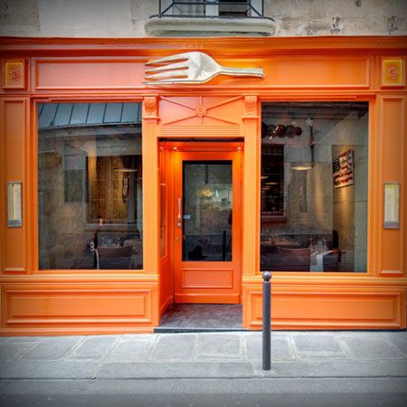 an orange store front with the door open