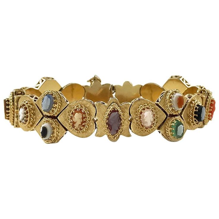 Victorian Revival 14 Karate Yellow Gold Cameo Slide Bracelet. Portrait silhouettes of both men and women on each charm, except one charm on the end, which is a marquise cut opal. Beautiful gold detail on each cameo setting, there is a Florentine finish on each multi-shaped gold charm and a prong-set gemstone or shell cameo. Gemstones include opal, coral, and tiger's eye plus mother of pearl and shell. The bracelet is in near pristine condition. The weight of the bracelet is 46.4 grams. Unique Jewelry Vintage, Victorian Bracelet, Slide Bracelet, Victorian Revival, Vintage Charm Bracelet, Gold Link Bracelet, Antique Bracelets, Victorian Gold, Accessories Diy Jewelry