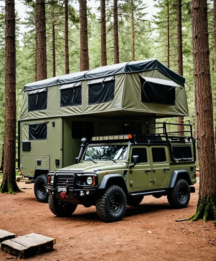 an off - road vehicle parked in the woods next to a camper with its roof up