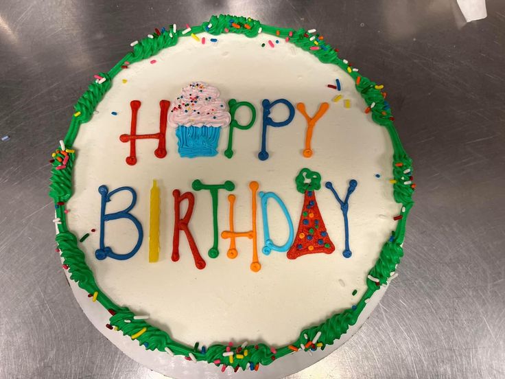 a birthday cake with the words happy birthday written on it in frosting and sprinkles