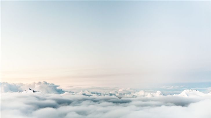 an airplane is flying above the clouds in the sky