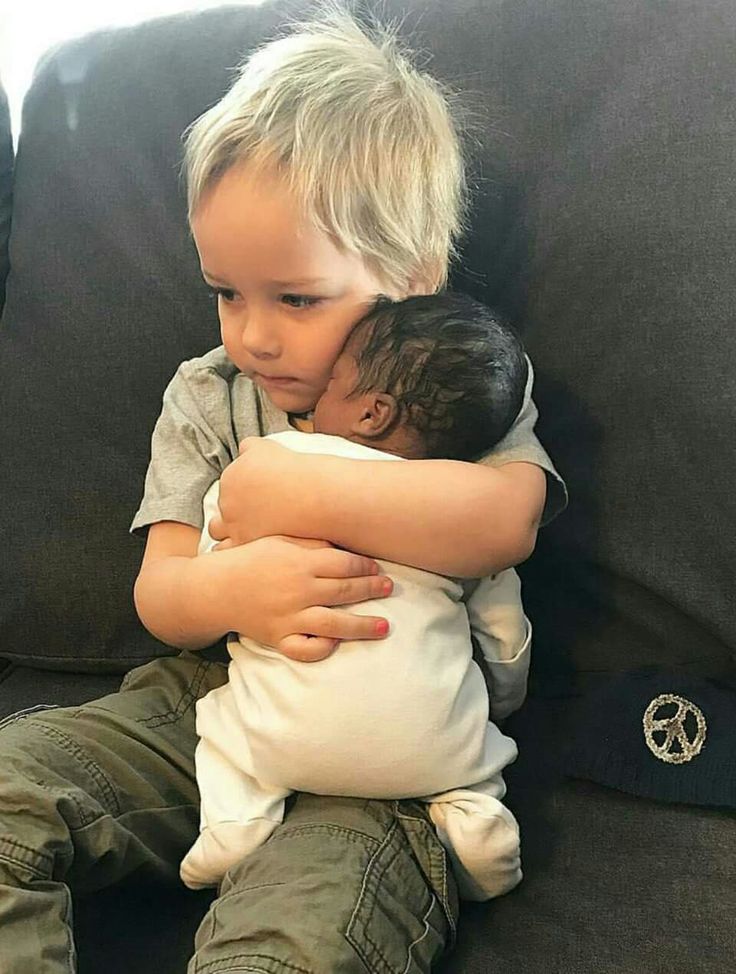 a little boy sitting on top of a couch hugging another child's head with the caption, some pictures need no words too bad most humans won't get it tho