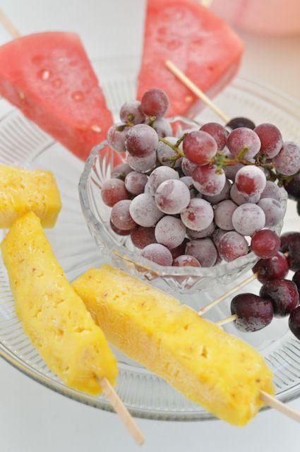 grapes, pineapples and watermelon on a plate with toothpicks