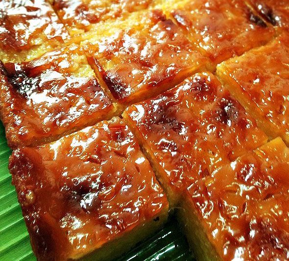 there is a cake that has been cut into squares and placed on a green plate