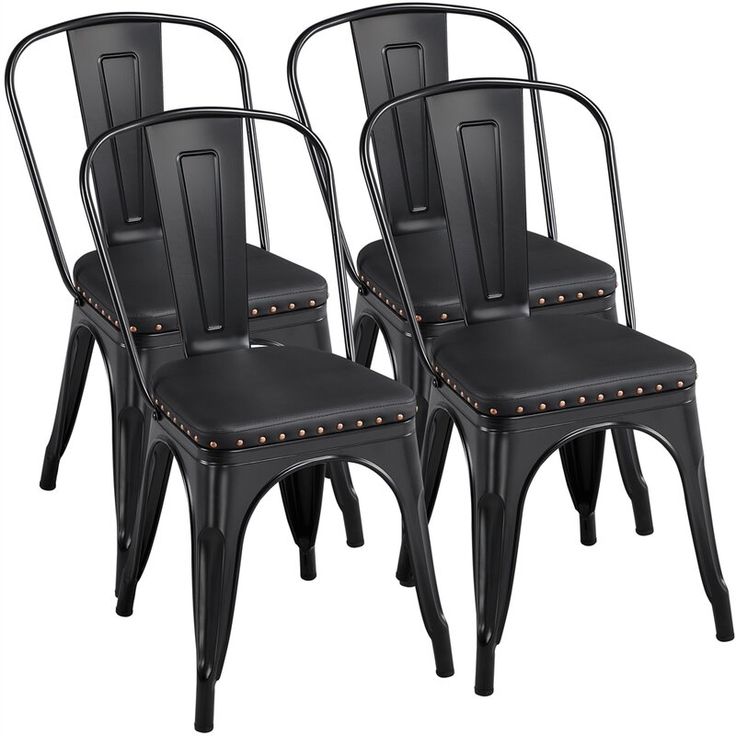 three black metal chairs with studded backs