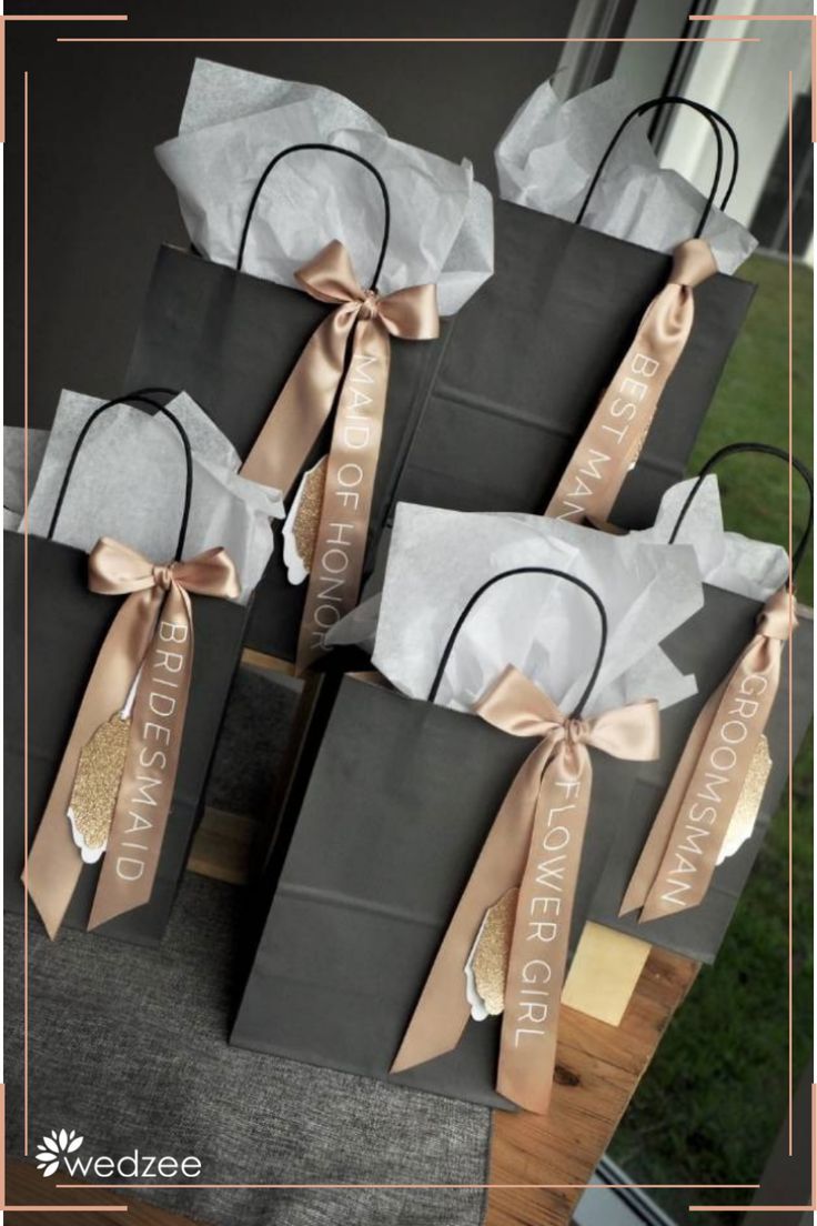 several bags with ribbons tied around them sitting on a table