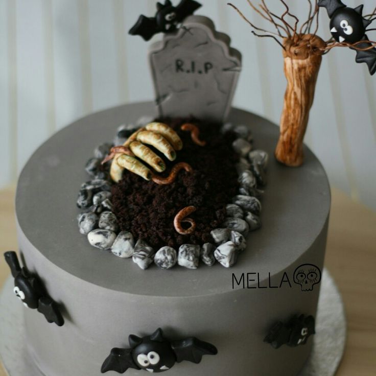 a cake decorated with halloween decorations on top of a table