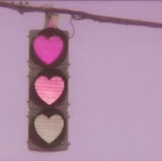 a traffic light with three hearts on it