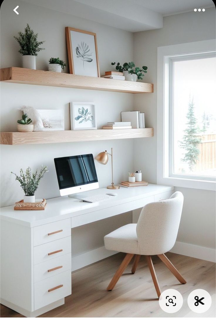 a desk with a computer on top of it and shelves above the desk, along with other items