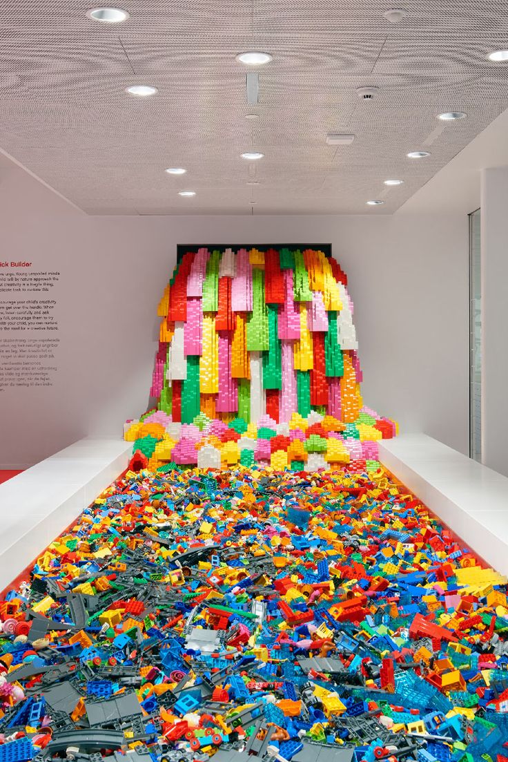 a room filled with lots of different colored legos on the floor and in the ceiling