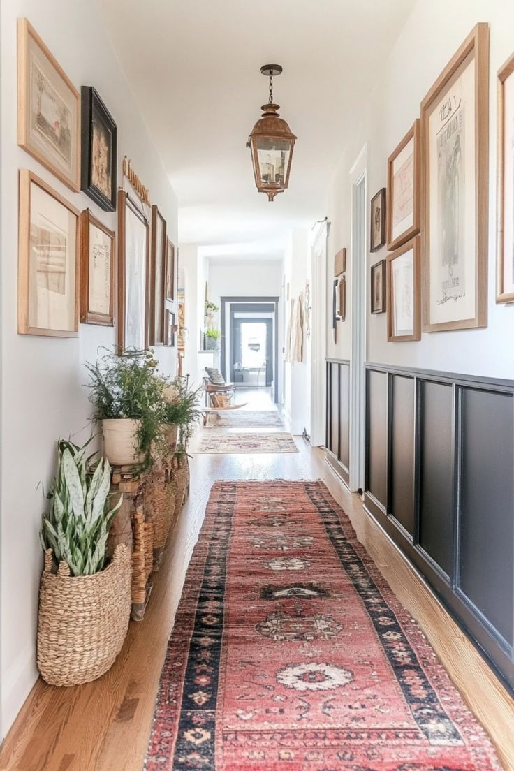 a long hallway with pictures on the wall and plants in baskets along the length of the corridor