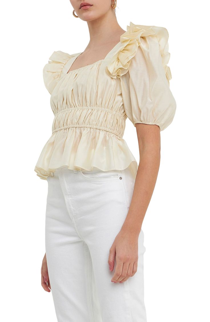 Shirring at the waist creates elegant shape on this puff-sleeve blouse crafted with frothy ruffles at the shoulders for dramatic flair. Square neck   Short sleeves   Lined   85% Tencel® lyocell, 15% polyester   Tencel lyocell is a sustainably produced fiber made with closed-loop processing   Hand wash, dry flat   Imported Spring Chic Puff Sleeve Top With Ruffle Hem, Feminine Puff Sleeve Top With Ruffle Hem For Brunch, Feminine Puff Sleeve Top With Ruffles, Elegant Spring Puff Sleeve Top With Ruffle Hem, Feminine Ruched Blouse With Puff Sleeves, Glamorous Spring Blouse With Ruffles, Elegant Puff Sleeve Top With Ruffle Hem For Spring, Chic Puff Sleeve Top With Ruffles For Brunch, Chic Smocked Top With Ruffle Hem For Brunch