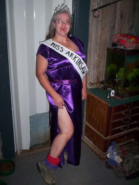 a woman in a purple dress and crown