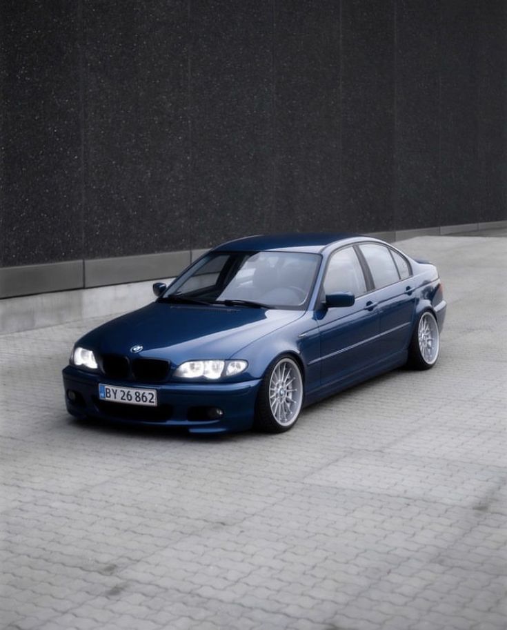 a blue car parked in front of a building