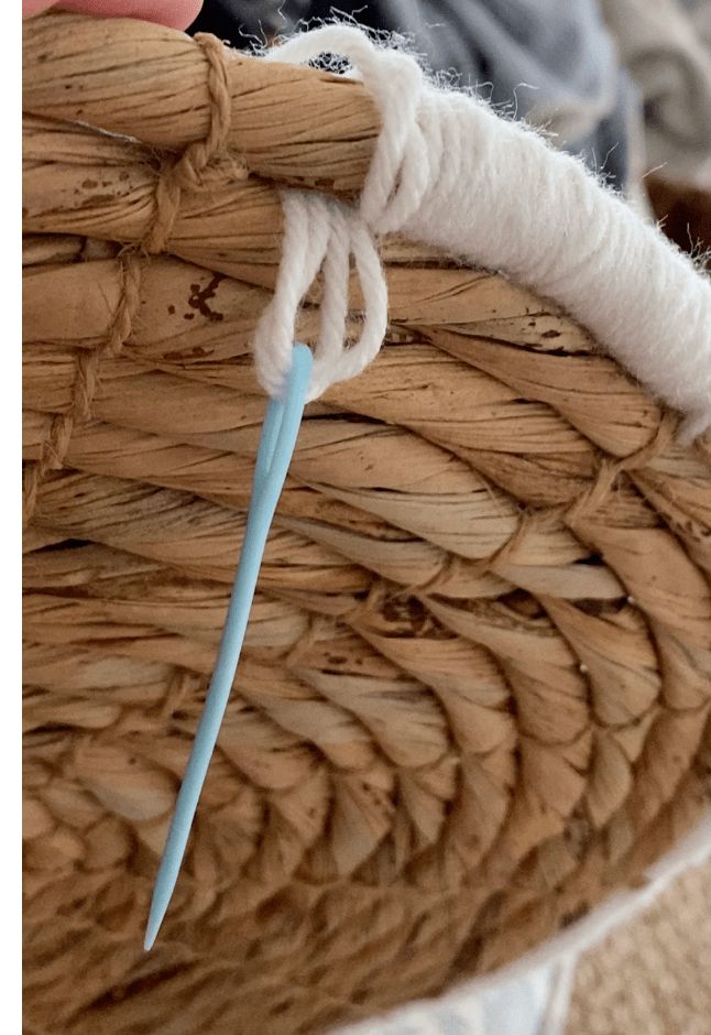 a close up of a piece of woven material with a blue needle sticking out of it