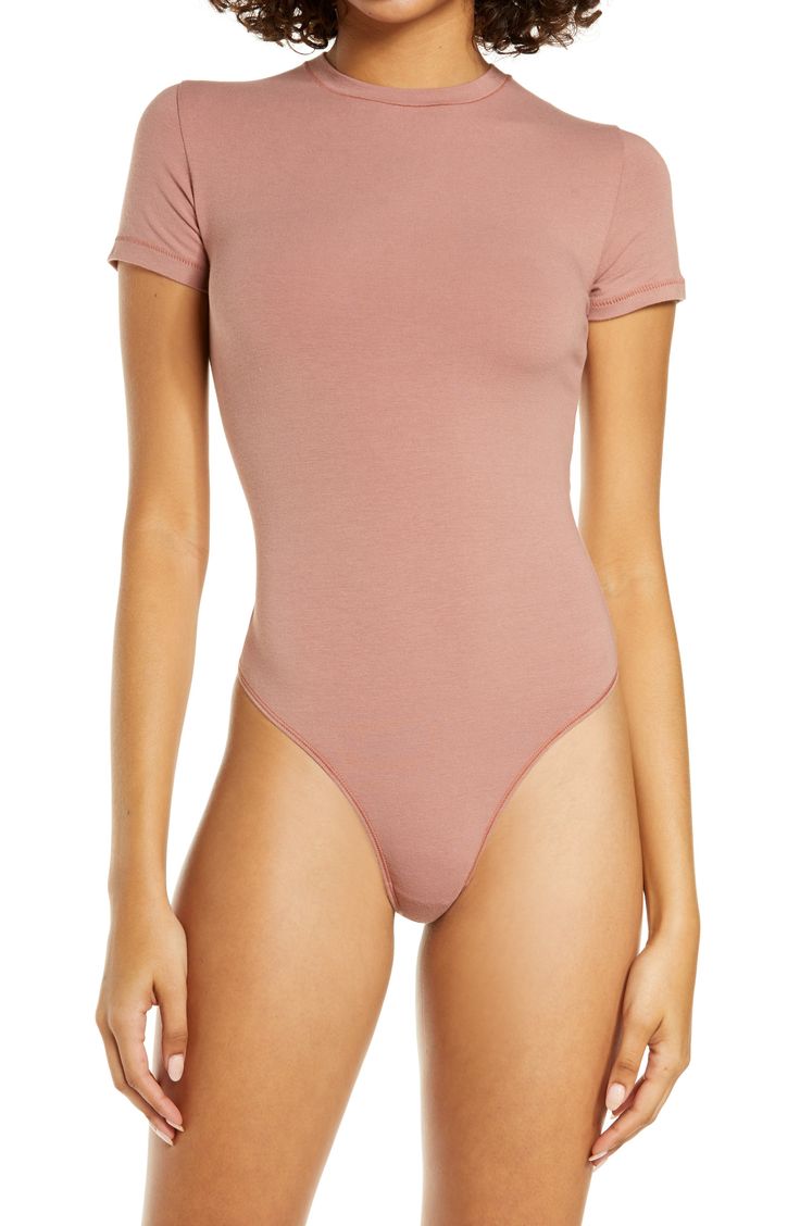 This fitted crewneck bodysuit from Kim Kardashian West's SKIMS gives the look of a tucked-in tee-making it perfect for everyday wear. The breathable stretch jersey hugs your curves while keeping you comfortable, so you can wear it as a base layer or alone. Style Name:Skims Stretch Cotton Jersey T-Shirt Bodysuit (Regular & Plus Size). Style Number: 6211586. Tshirt Bodysuit, Ribbed Knit Bodysuit, High Neck Bodysuit, Mock Neck Bodysuit, Scoop Neck Bodysuit, Shirt Bodysuit, Cami Bodysuit, Square Neck Bodysuit, Shapewear Bodysuit