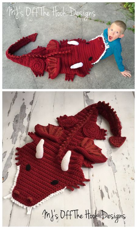 a baby wearing a red crocheted dragon costume