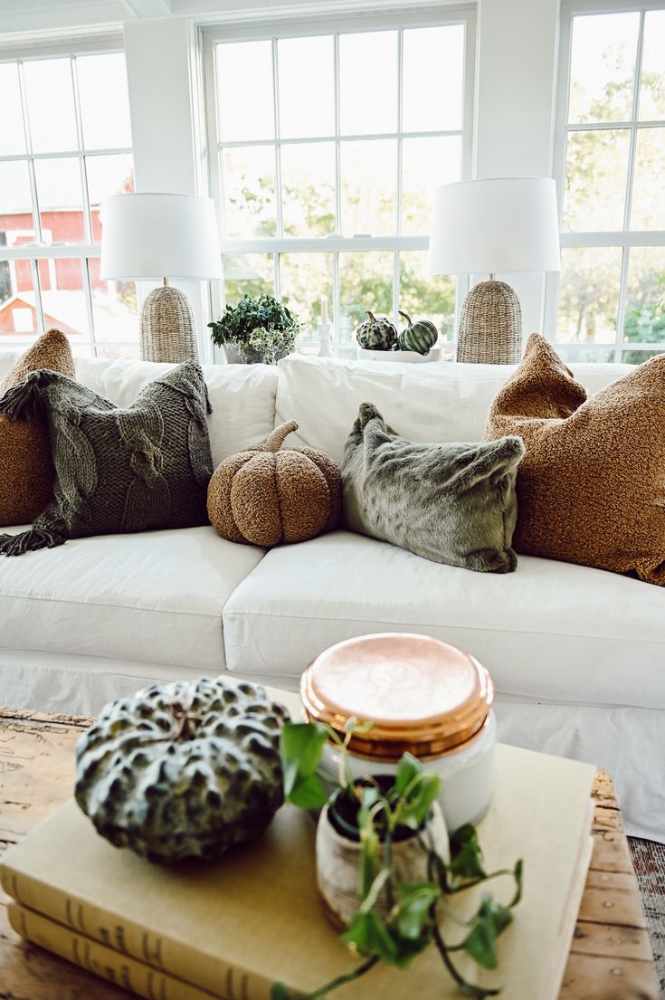 a white couch with pillows on top of it